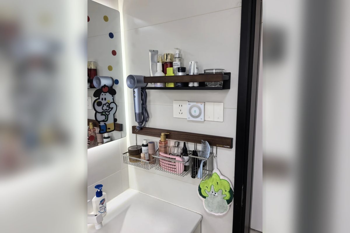 Wall-mounted bathroom caddy above a sink with small baskets for daily toiletries.