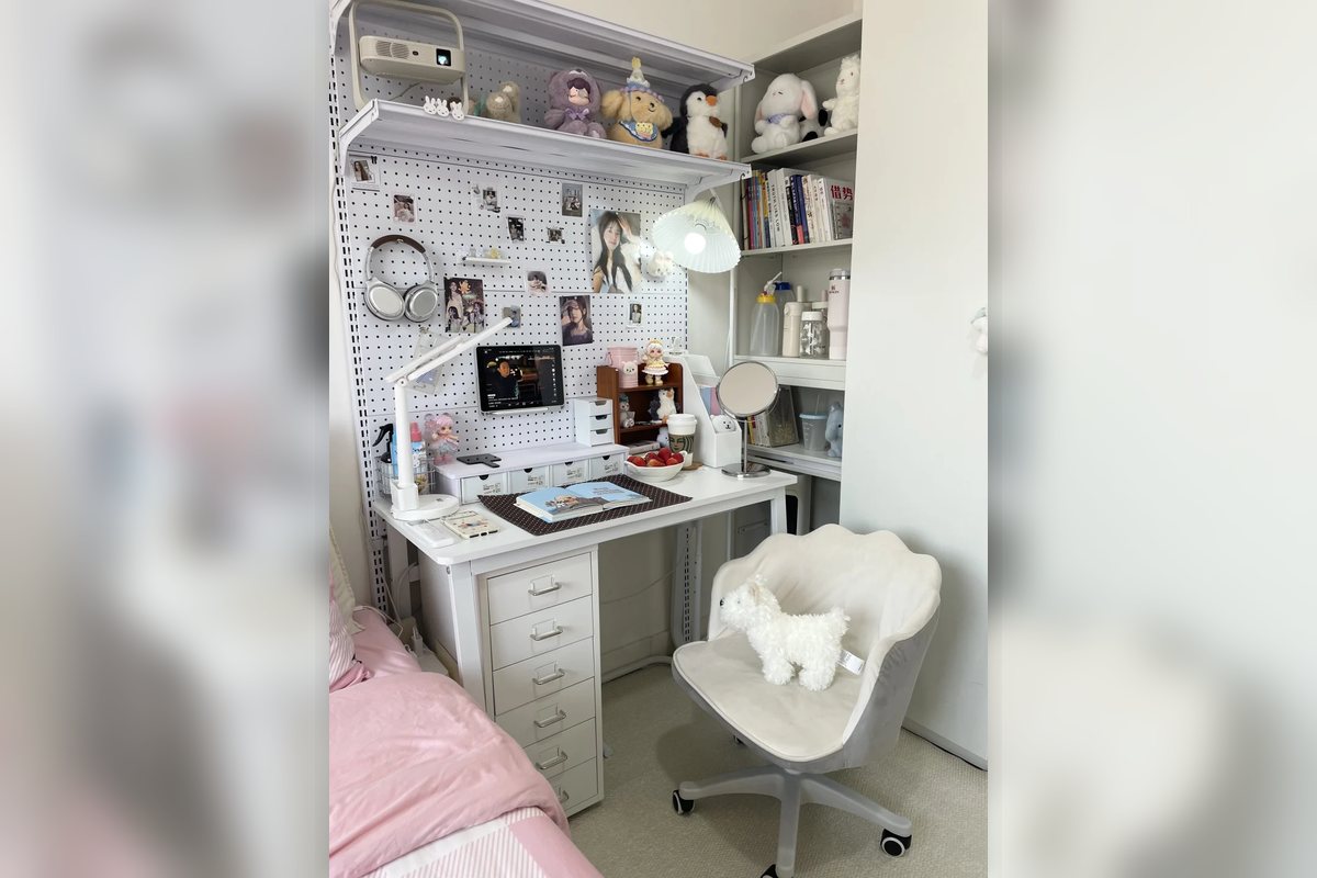 Small desk zone with shelves, pegboard storage, and a compact chair.