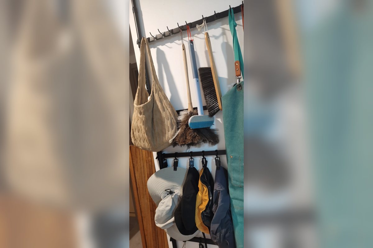Doorway hook and hanging storage zone in a compact apartment entry.