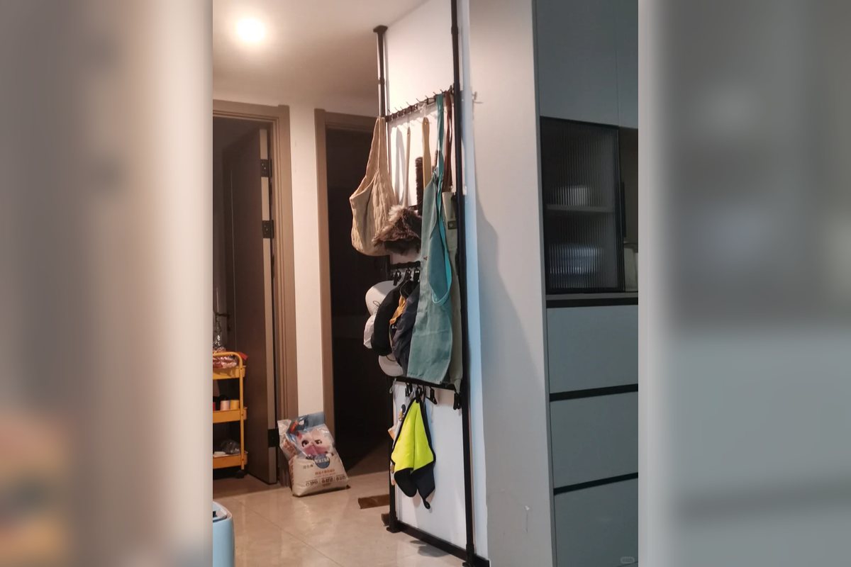 No-drill hanging storage rack set up near a doorway in an apartment.